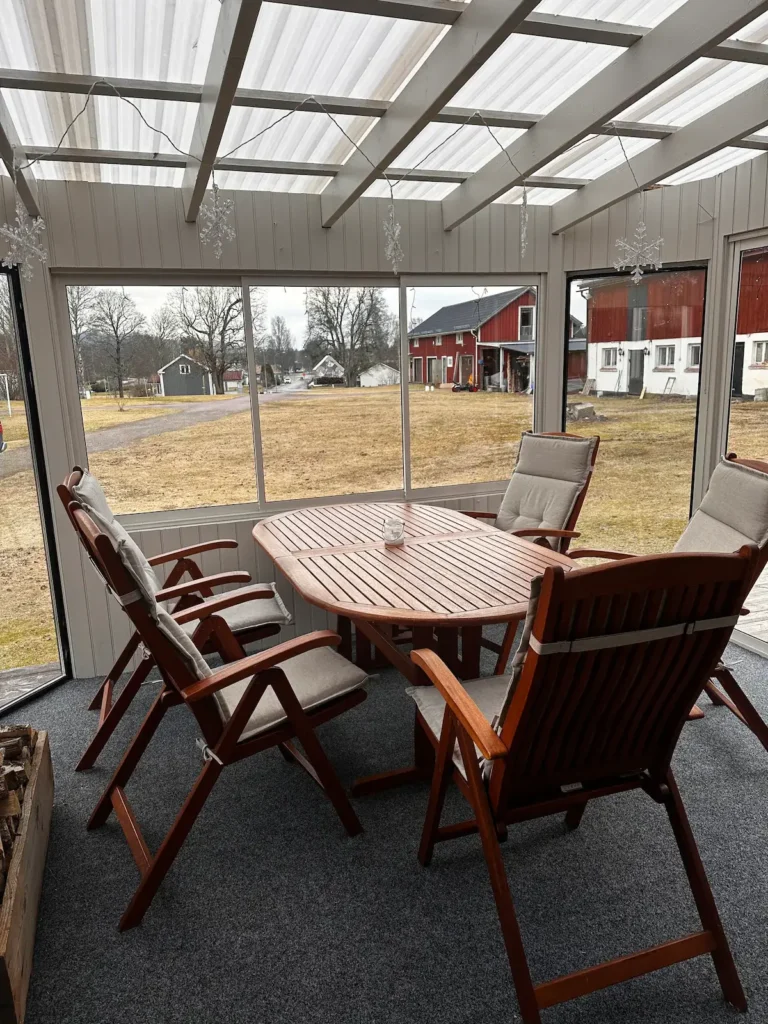 Covered veranda with outdoor dining area at Stuga Värmland